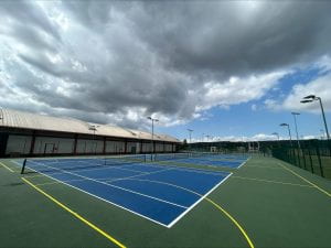 Freshly painted outdoor courts at Coombe Dingle - the courts are bright blue.